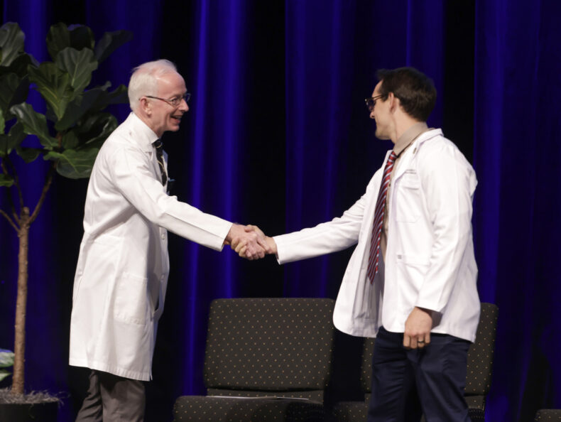 Jonathan Dillard of Nashville shakes hands with Donald Bradley, MD, during the White Coat Ceremony. (photo by Donn Jones)