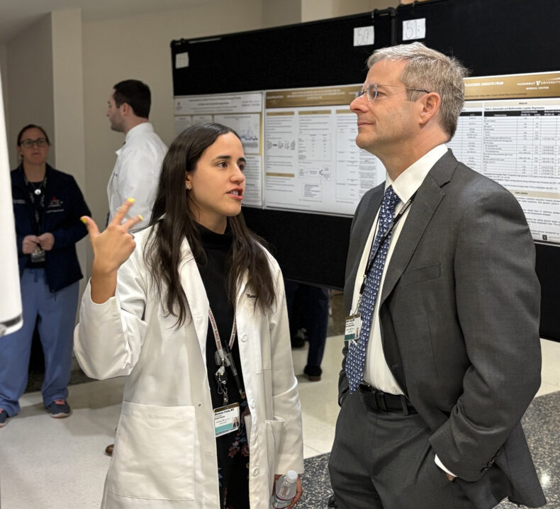 General surgery resident Marianna Frazee, MD, discusses her research with Seth Karp, MD, H. William Scott Jr. Professor of Surgery and chair of the Section of Surgical Sciences. Frazee’s work addresses provider and patient reporting of health-related social needs to better deliver quality care for all during the transplant evaluation process. (photo by Jill Clendening)