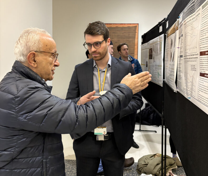 Naji Abumrad, MD, adjunct professor of Surgery, left, talks with research fellow Patrick Meyers, MD, about his work. Meyers’ research examines the mortality difference for veterans undergoing thoracic surgical resections in community health facilities compared to Veterans Affairs facilities. (photo by Jill Clendening)
