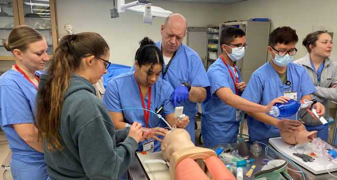 VUMC SMART Program Manager Christopher Brown, CC-P, center, teaching SMART rotators critical skills during February rotation. (Photo by Sfc. Justin Theodos)