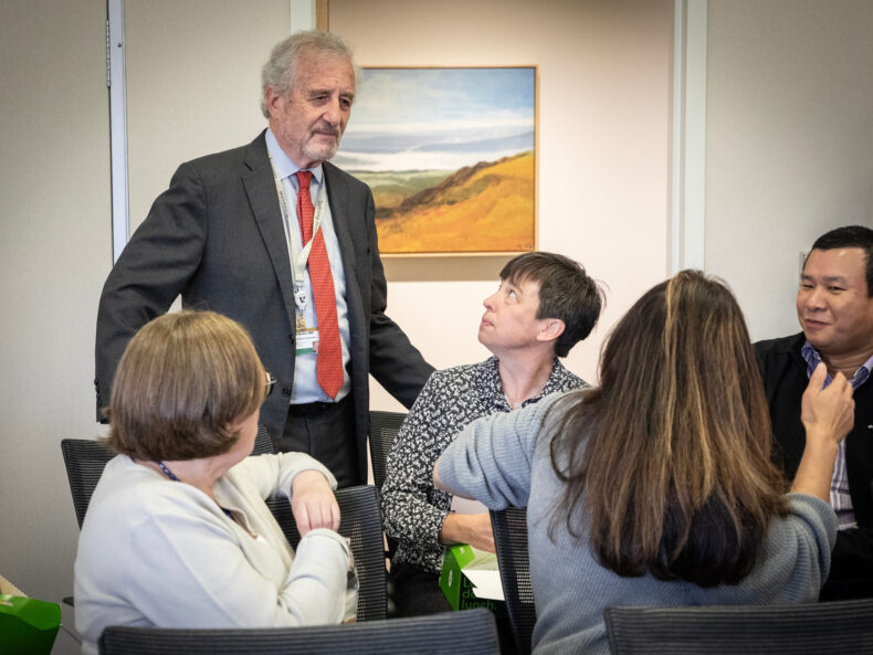 Dan Roden, MD, chats with colleagues during a break in the symposium. (photo by Erin O. Smith)