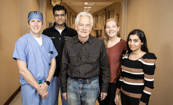Doug Floyd, center, with, from left, Ryan Lefevre, MD, Kashish Goel, MD, Natalie Jackson and Sarah Seriwala. (photo by Erin O. Smith)
