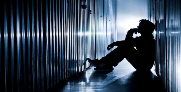 depression seated man in silhouette