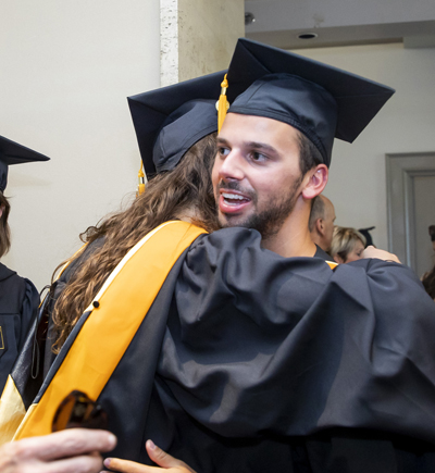 Drew Lawler gets a hug from fellow VUSN graduate Julia Sacha.