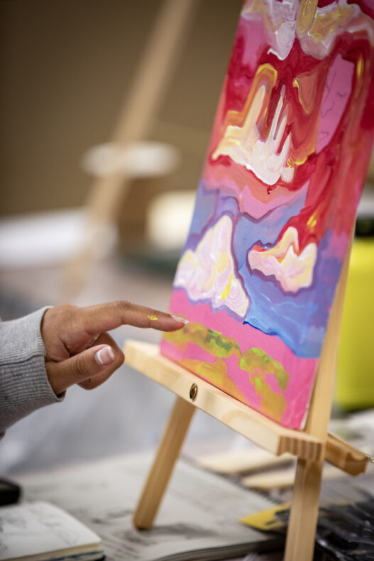 Roz Baxter works on her painting. (photo by Erin O. Smith)