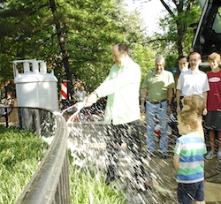 Chuck Sanders breaking Champagne bottle