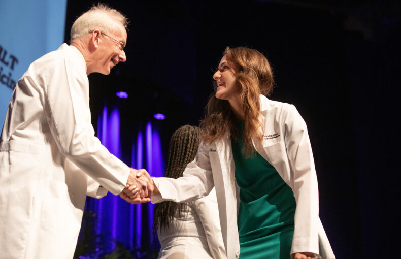 Jeff Balser, MD, PhD, congratulates Jarod Scott Lowe. (photo by Erin O. Smith)