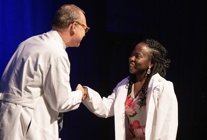 Jeff Balser, MD, PhD, congratulates Oluwateniayo Omolola Ogunsan. (photo by Erin O. Smith)