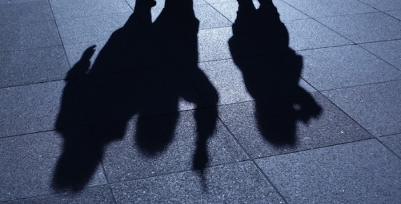 silhouette of three men with guns