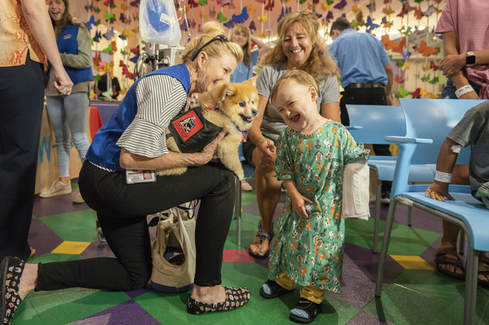  Patient Cole Ringer, 2, and his mother, Emilie, are delighted to interact with volunteers Swoosh the dog and his handler, Michelle Thompson, at the annual Dog Days of Summer Paw-ty on July 17 at Monroe Carell Jr. Children’s Hospital at Vanderbilt. The event featured a dog show, a meet-and-greet with pet volunteers and updates on the Mars Petcare Pet Therapy Fund and the upcoming arrival of Children’s Hospital’s facility dog.