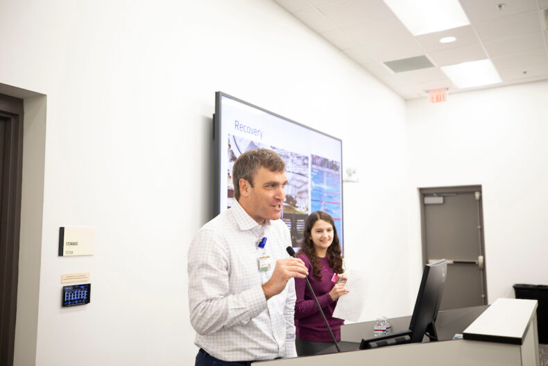 Daniel Dulek, MD, director of the Pediatric Immunocompromised Infectious Diseases Service, describes Maggie Weiss' treatment and recovery during the clinical presentation. (photo by Susan Urmy)