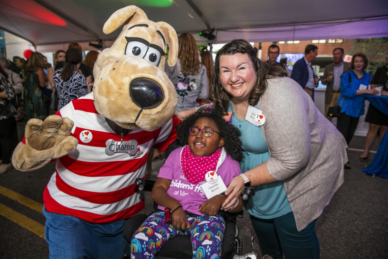 Patient ambassador Charlotte Bynum (middle) and her mom, Alison, take a photo with mascot Champ at the Growing to New Heights celebration in 2015 to celebrate the kickoff of the four-floor expansion at Monroe Carell Jr. Children’s Hospital at Vanderbilt. (photo by Anne Rayner)
