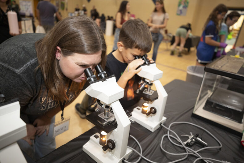 Two young explorers peer into the hidden world of microorganisms during MEGAMicrobe, Sept. 27 at Jones Paideia Magnet School in Nashville. (photo by Susan Urmy)