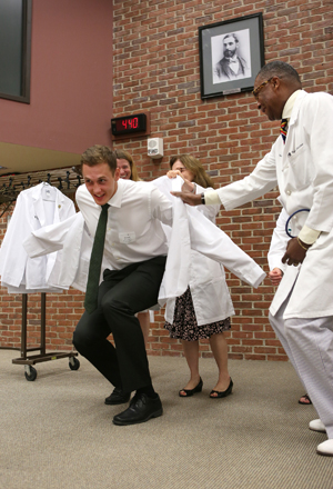 Colby Wollenman gets a little help from Bonnie Miller, M.D., and Andre Churchwell, M.D. (photo by Anne Rayner)