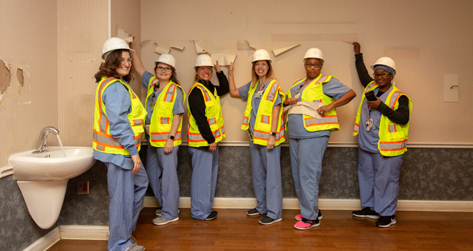The Department of Obstetrics and Gynecology recently kicked off the first phase of renovations for the Labor and Delivery unit. Staff from the department helped “retire” the wallpaper in the current delivery rooms by tearing it off the walls. The construction is part of an approximately year-long project to overhaul the birthing area at VUMC to enhance the patient experience with more amenities, a modern design and increased post-partum privacy. The project began this summer with renovations in the Obstetrics Triage unit.  Shown here are, from left, Patricia Cook, RN; Tiffany Lewis, RN; Rosha Webb, RN; Cricket Ramsey, RN; Tanya Dixon; and Patricia Polk.