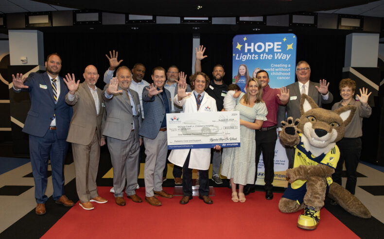 Representatives from Hyundai Hope on Wheels, VUMC, patient families and Nashville FC mascot Tempo pose for a group photo during the Hyundai Hope on Wheels check presentation. (photo by Erin O. Smith)