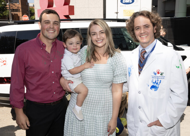 The Clayton family — Corey, Lauren and 1-year-old Wyatt — with Jason Schwartz, MD, PhD. (photo by Erin O. Smith)