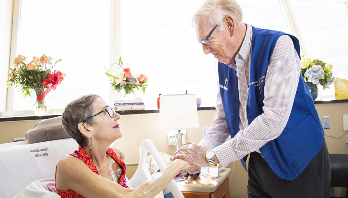 Dan Kula, a volunteer with Vanderbilt Vigil Volunteers, visits with patient Gwenthian Hewitt. The program provides support for seriously ill patients at VUMC who might not have a loved one available to be at their bedside. 