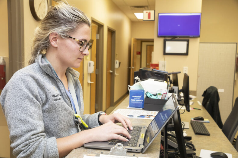 Avery Bogart, an MD/PhD student, pulls up a patient’s medical record in advance of their visit. (photo by Susan Urmy)