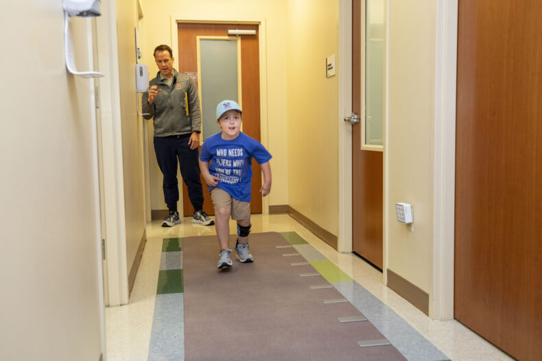 Hoyt Summerville walks on the GAITRite device while Ken Swantek PT, DPT, looks on. (photo by Susan Urmy)