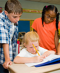 Students helping another student with her work