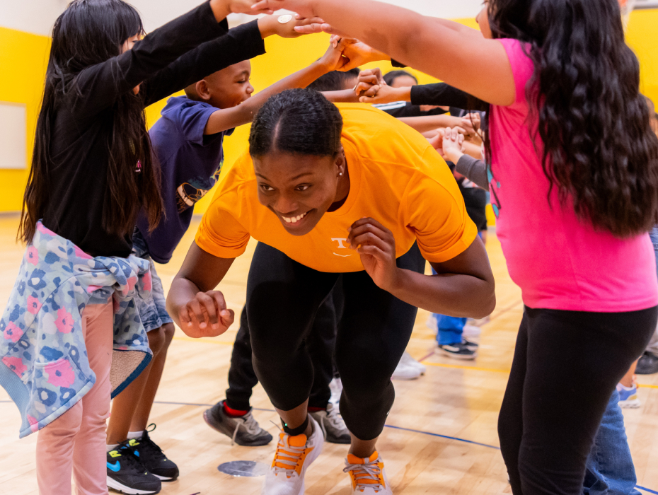 Outside hitter Morgahn Fingall, #7 of the Tennessee Lady Volunteers volleyball team, works with kids in a PE class at Lonsdale Elementary