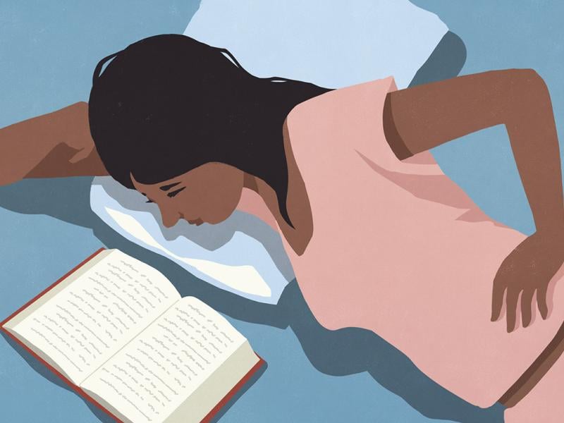 Reclining figure reading in bed