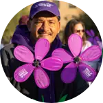 Participant holding flowers in support of an Alzheimer's Association event.