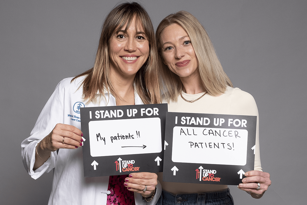 Doctor and patient holding placards, symbolizing advocacy for cancer patients.