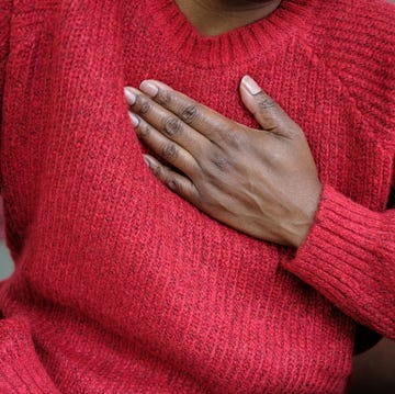 woman holding chest woman holding chest