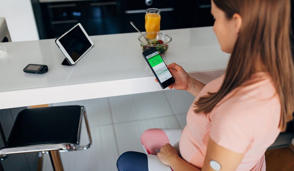 Woman using telemedicine to check glycemic levels