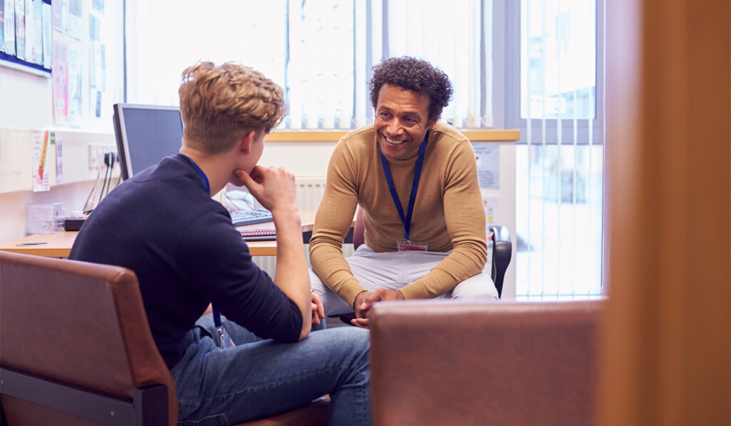 Doctor or counselor consulting young man