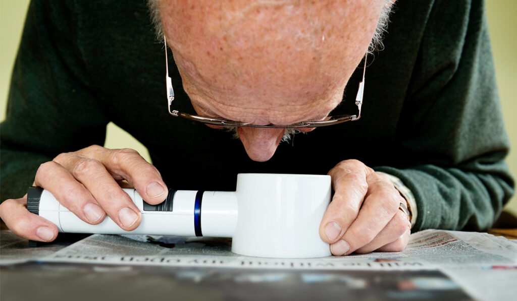 Man using magnifying glass