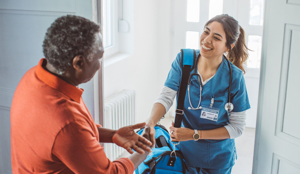 Home health worker greets person at door