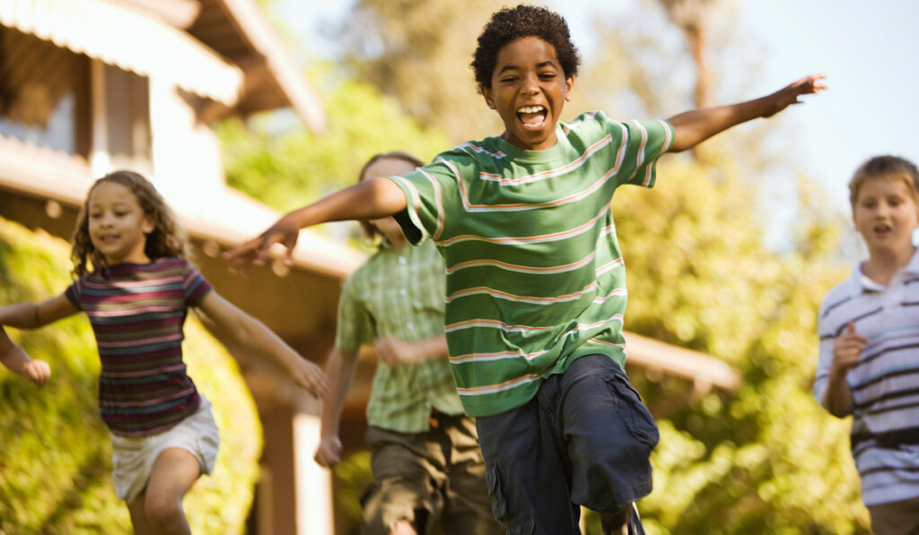 Happy kid running with arms out