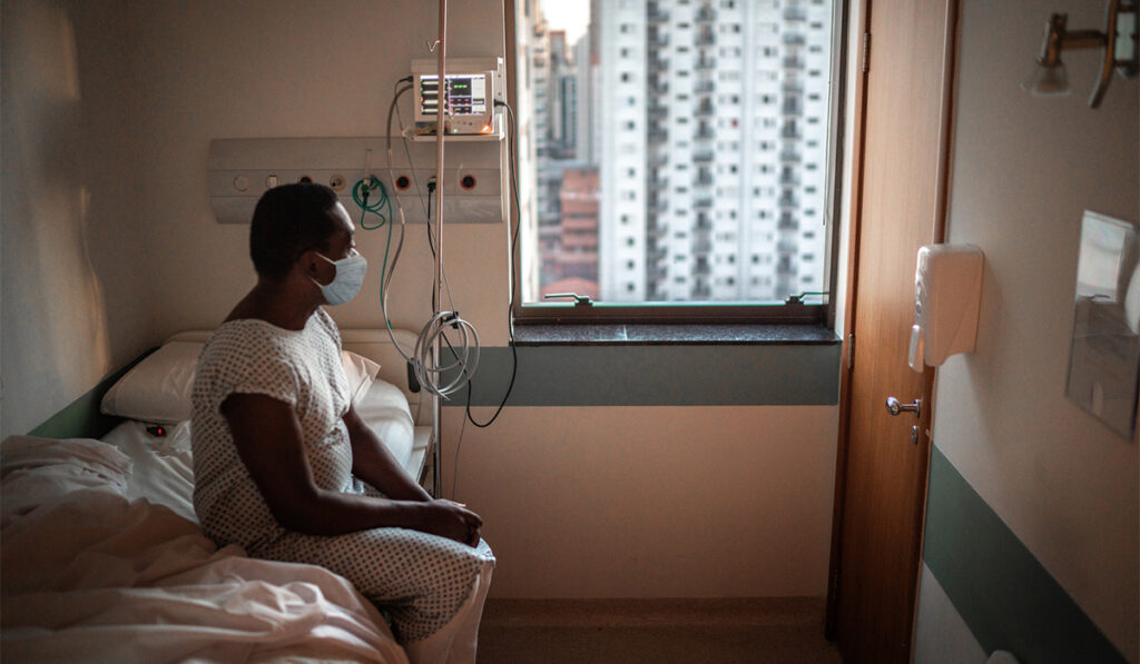 Lonely looking black patient in hospital room