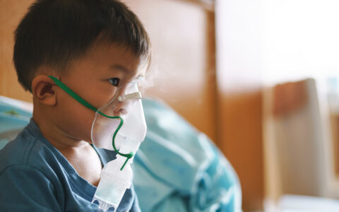 child with breathing help