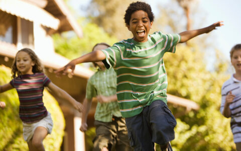 Happy kid running with arms out