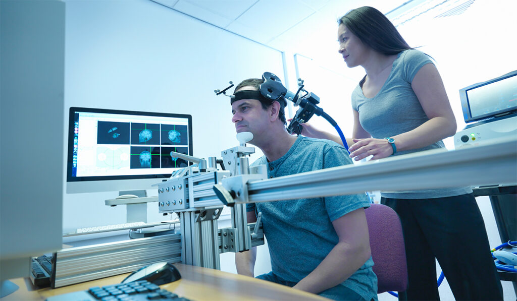 A clinician administering transcranial magnetic stimulation
