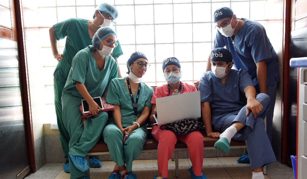 Orbis healthcare providers looking at computer screen