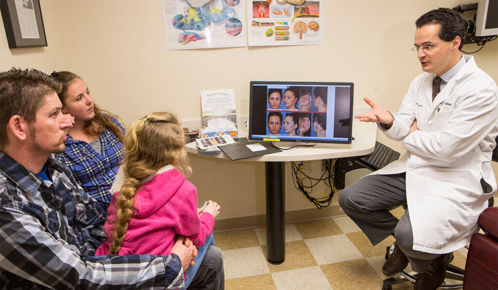 Dr. Stephan consulting with pediatric patient and family