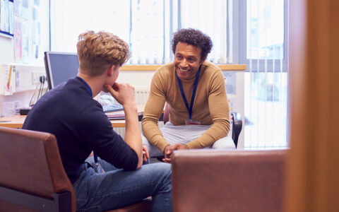 Doctor or counselor consulting young man