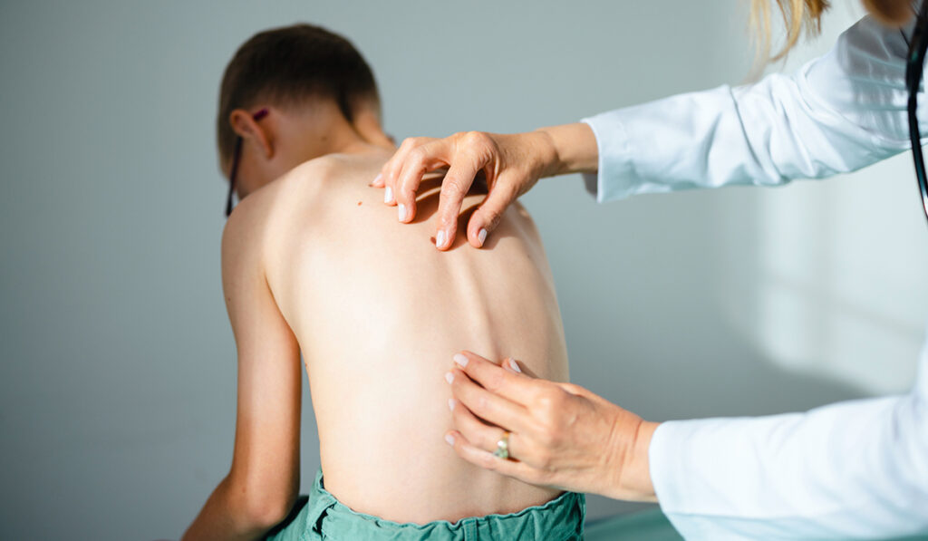 Child having spine checked for scoliosis