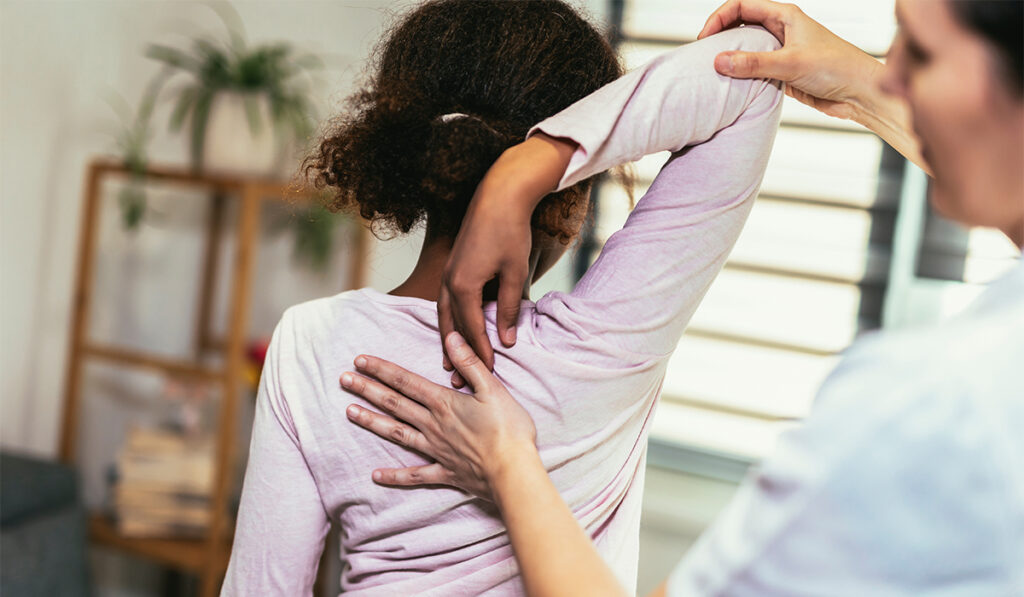 Provider checking a child's spine