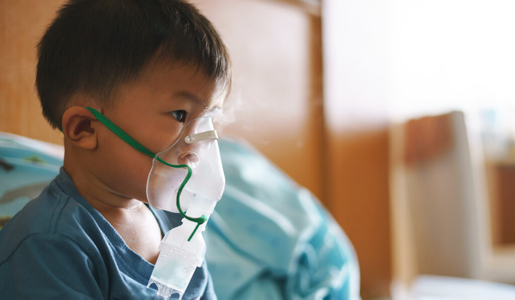 child with breathing help