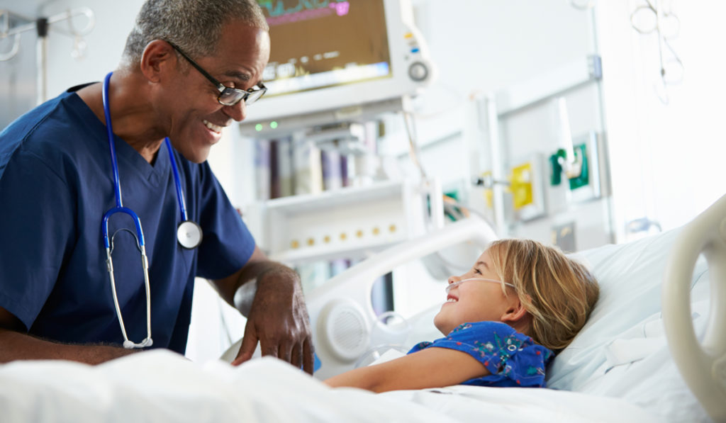 Doctor speaking to a child patient in ICU.