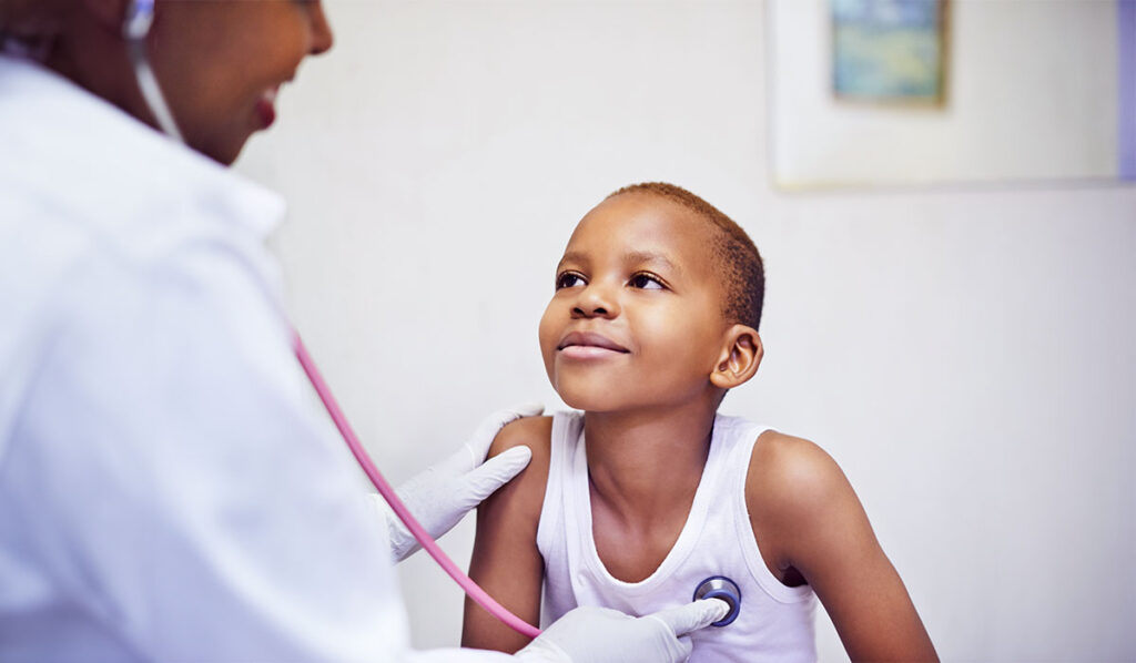Black boy in white tank top at the doctor getting his heart checked