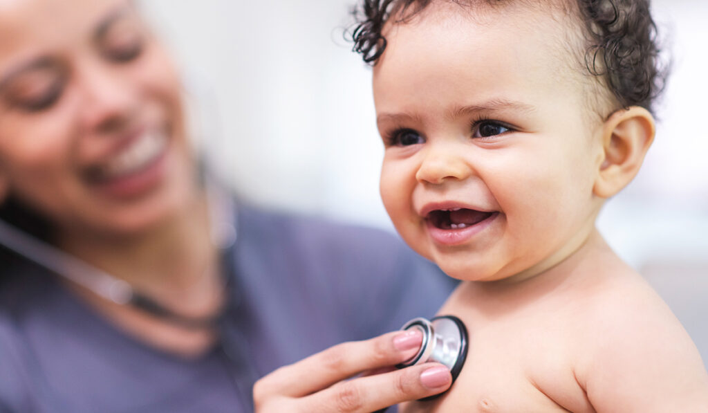 Doctor checking baby's heart
