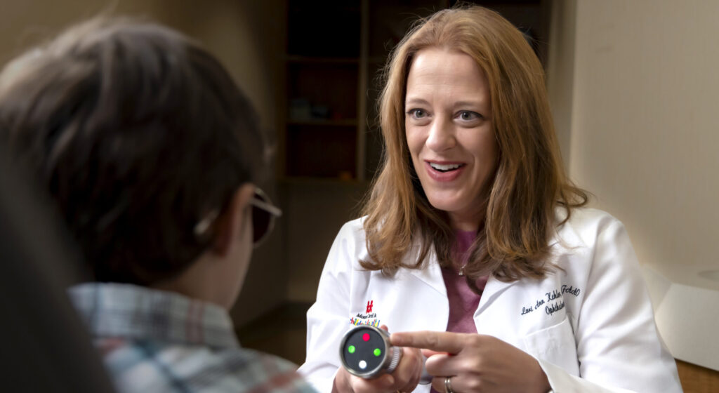 Lori Ann Kehler, O.D., in clinic with a patient