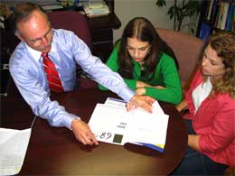 students at table with counselor